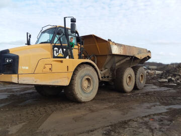 Young boy acting as a heavy equipment operator at Boyas Excavating, landfill near Cleveland